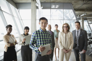 Portrait of business people standing together in office building