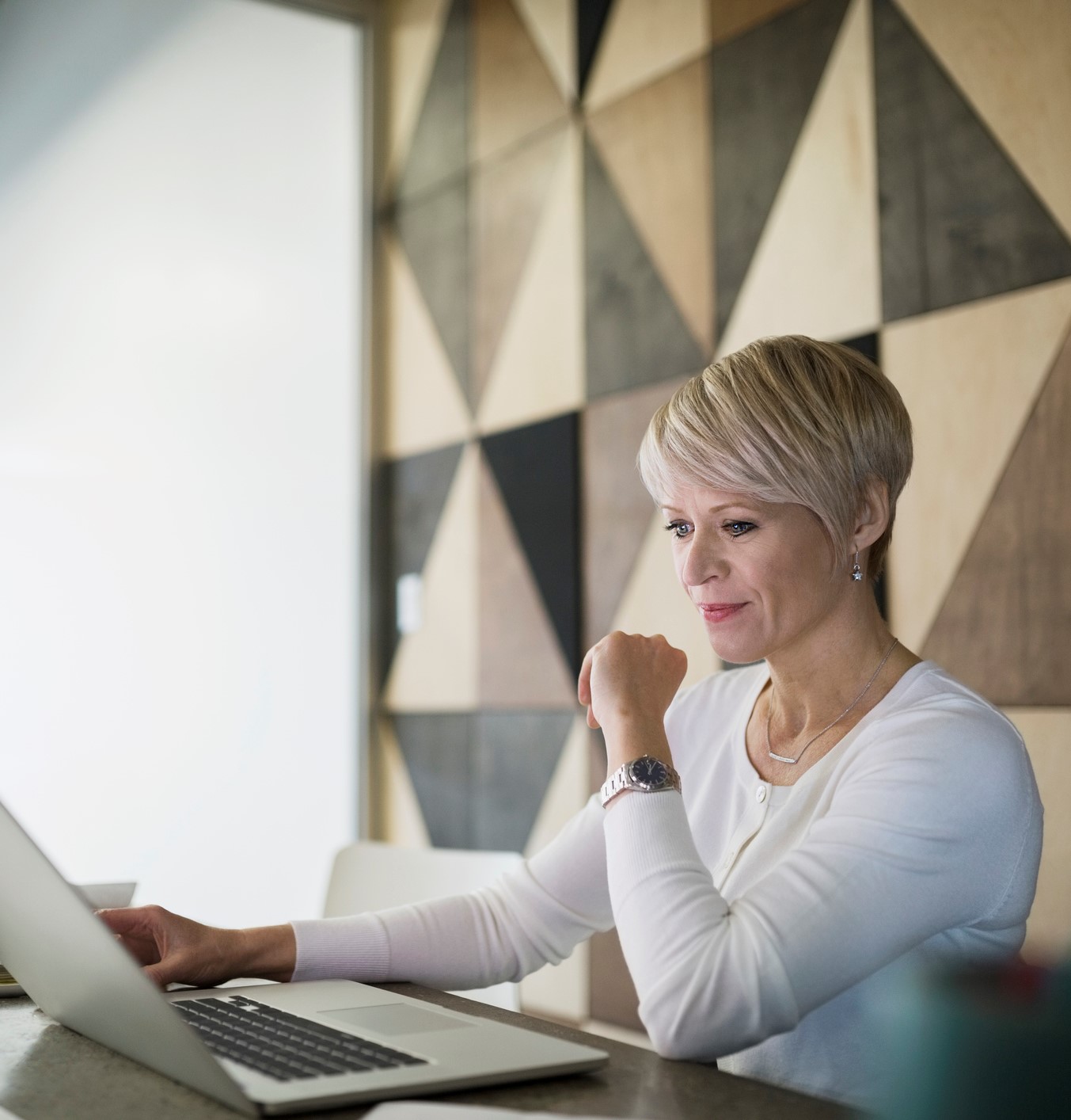 Focused businesswoman working at laptop in conference room
