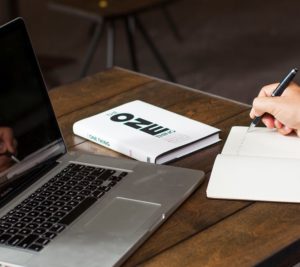 'the one thing' book next to a laptop on a desk