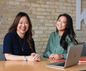 jessica ye and lisa joa sitting at desk