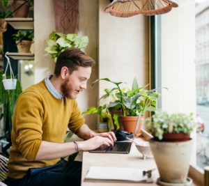 colorfully dressed man working on his laptop